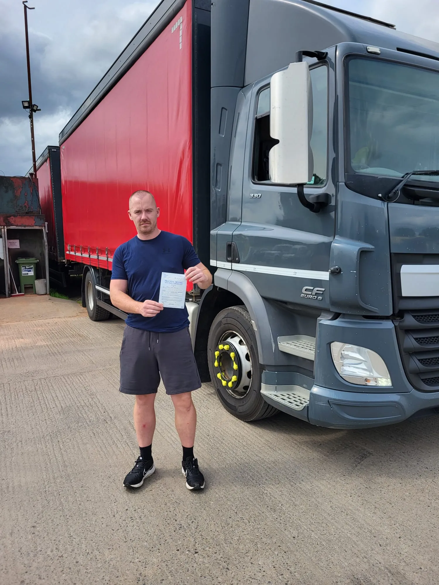 A man standing in front of a large truck.